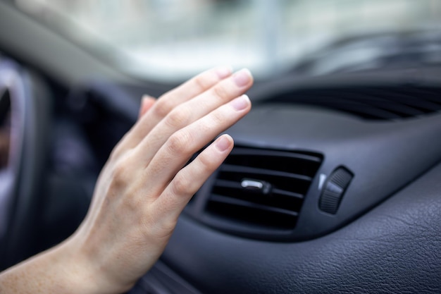 Mulher ajustando o resfriamento dentro do carro Close do motorista manual verificando o ajuste do ar do condicionamento do sistema de resfriamento com fluxo de ar frio no carro