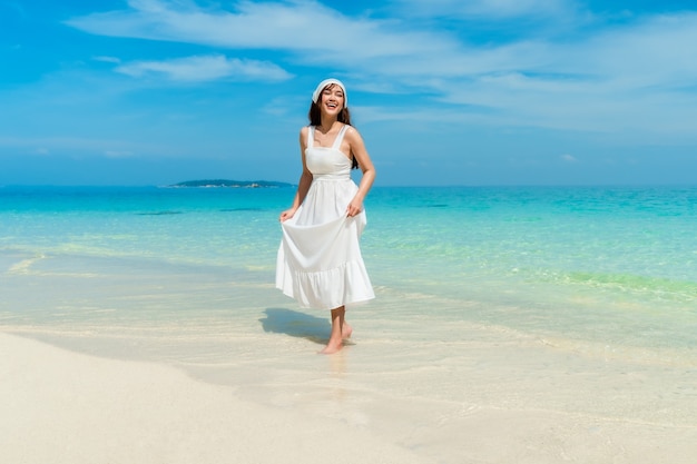 Mulher alegre na praia do mar na Ilha de Koh MunNork, Rayong, Tailândia