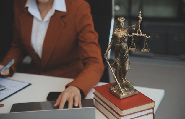 Mulher americana advogada ou empresária africana trabalhando com laptop pesquisando analisando dados lendo documentos de contrato trabalhando com livros de direito martelo da justiça conceito de advogado de consultoria