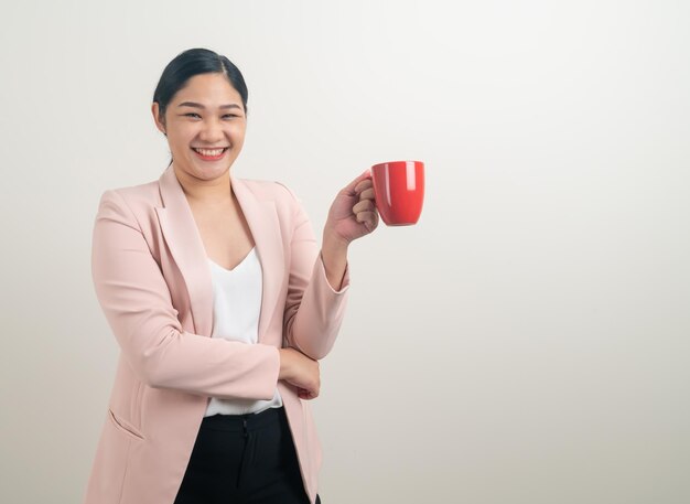 Mulher asiática com a mão segurando a xícara de café no fundo branco