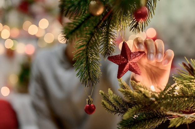 Foto mulher asiática decorar para o natal sozinha em casa. família comemora e feliz ano novo em casa.