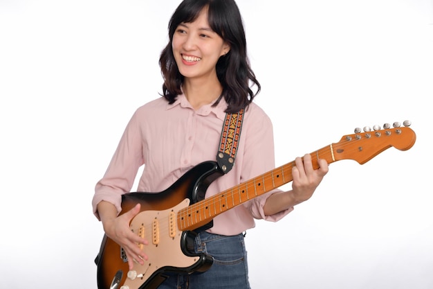 Mulher asiática tocando uma guitarra elétrica vintage sunburst isolada no fundo branco