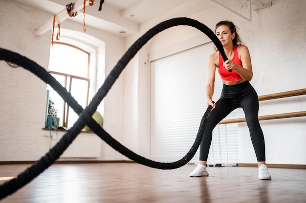 Mulher atlética treinando cardio esportivo no estúdio de fitness usa estilo de vida ativo de equipamentos esportivos
