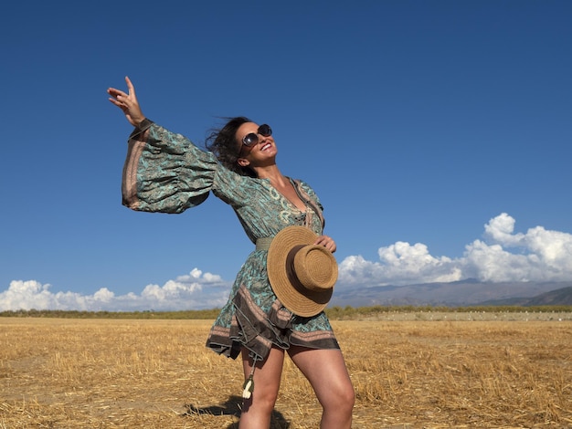 Mulher boho elegante em campo ensolarado