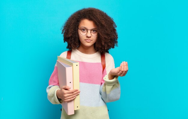 Mulher bonita afro fazendo capice ou gesto de dinheiro, dizendo para você pagar suas dívidas !. conceito de estudante