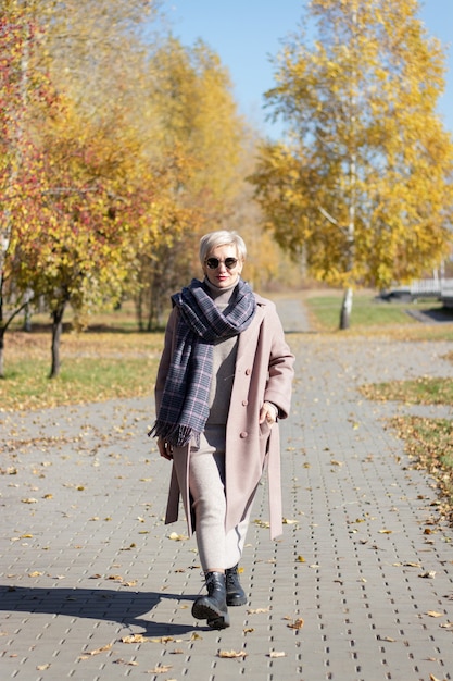 Mulher bonita caminhando no parque no outono