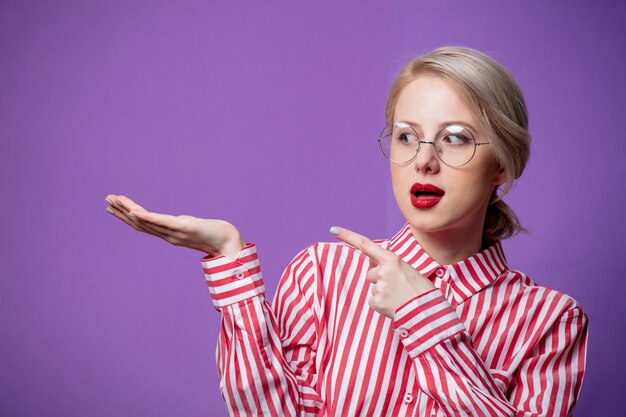 Mulher bonita com camisa listrada vermelha segurando a mão