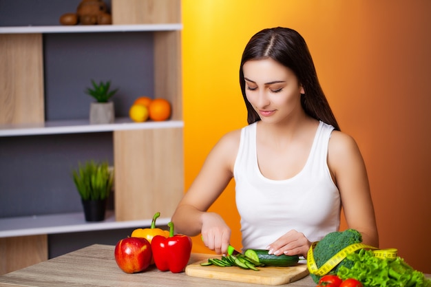 Mulher bonita com legumes frescos e frutas, levando um estilo de vida saudável