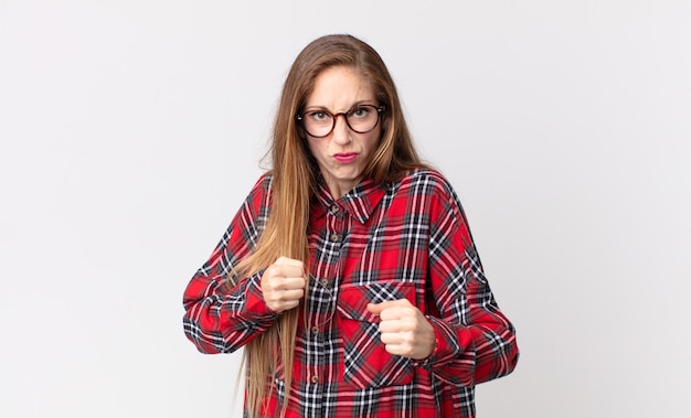 Mulher bonita e magra que parece confiante, irritada, forte e agressiva, com punhos prontos para lutar em posição de boxe