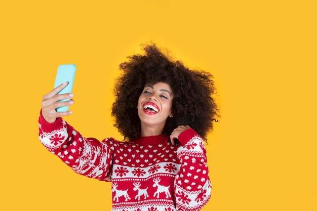 Mulher bonita fazendo selfie por smartphone no Natal