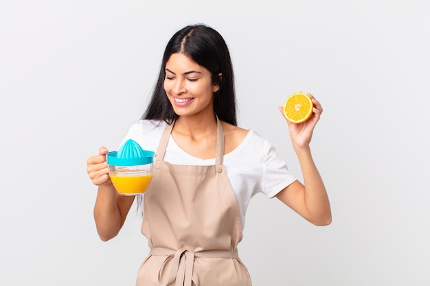 Mulher bonita hispânica do chef. suco de laranja e conceito de café da manhã