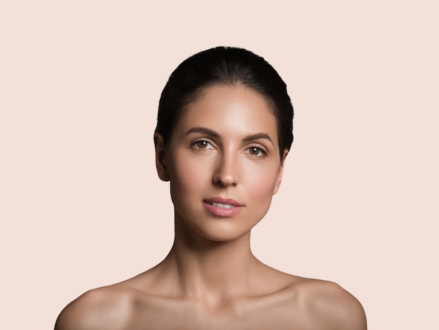 Mulher bonita pele saudável beleza rosto conceito cosmético cor de fundo. Cor de rosa.