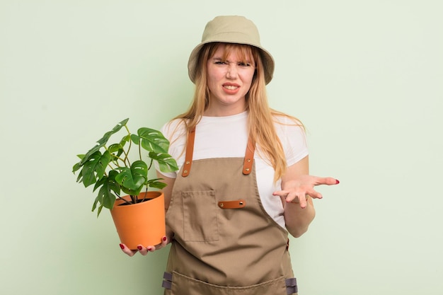 Mulher bonita ruiva olhando com raiva, irritada e frustrada. conceito de jardineiro