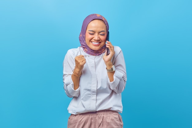 Mulher bonita sorrindo amplamente ligando para amigos via smartphone