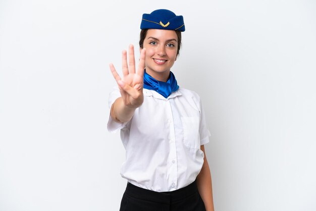 Mulher caucasiana com aeromoça de avião isolada no fundo branco feliz e contando quatro com os dedos