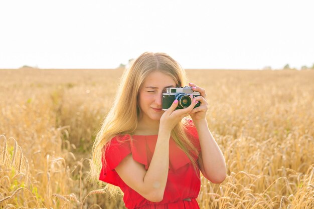 Mulher com câmera fotográfica retrô