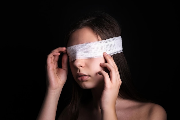 Foto mulher com os olhos vendados em fundo escuro censura direitos humanos opressão ou conceito de repressão