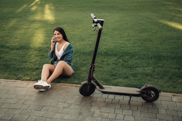 Mulher com scooter elétrico na rua da cidade