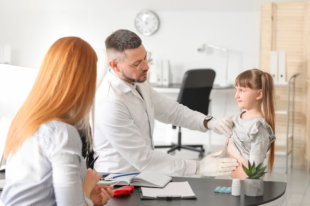 Mulher com sua filha visitando gastroenterologista na clínica