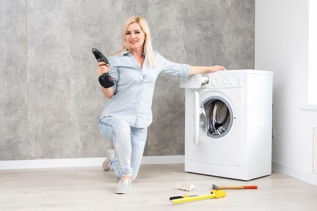 mulher consertando máquina de lavar quebrada