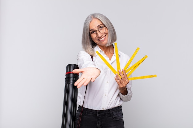 Mulher de meia-idade sorrindo feliz com um olhar amigável, confiante e positivo