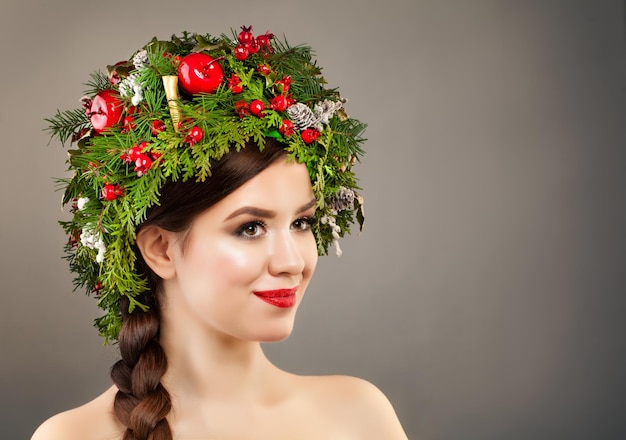 Mulher de Natal com coroa de flores da árvore de Natal, maquiagem e penteado de trança no fundo do banner. Conceito de natal