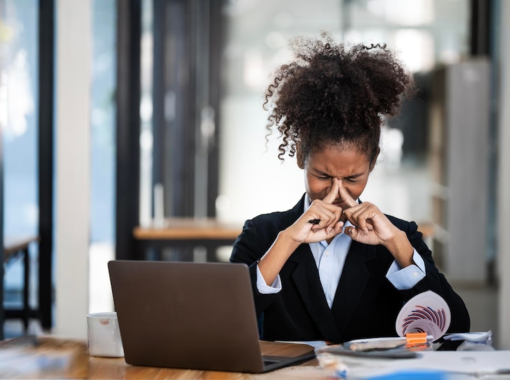 Foto mulher de negócios africana estressada se concentrando no trabalho usando laptop no escritório