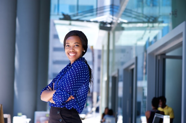 Mulher de negócios africanos a sorrir com os braços cruzados