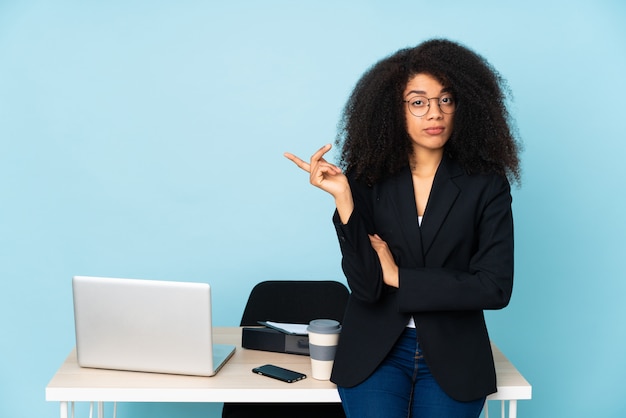 Mulher de negócios americano africano trabalhando em seu local de trabalho infeliz por não entender algo