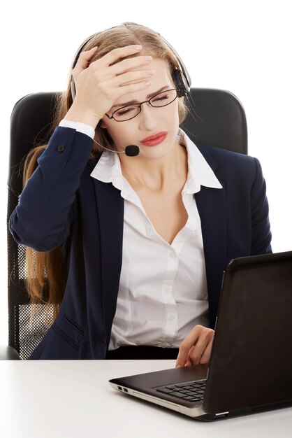 Foto mulher de negócios com laptop na mesa sentada contra um fundo branco