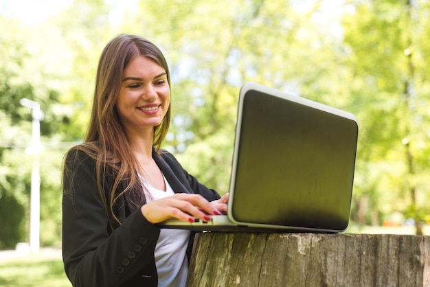 Mulher de negócios com laptop no parque