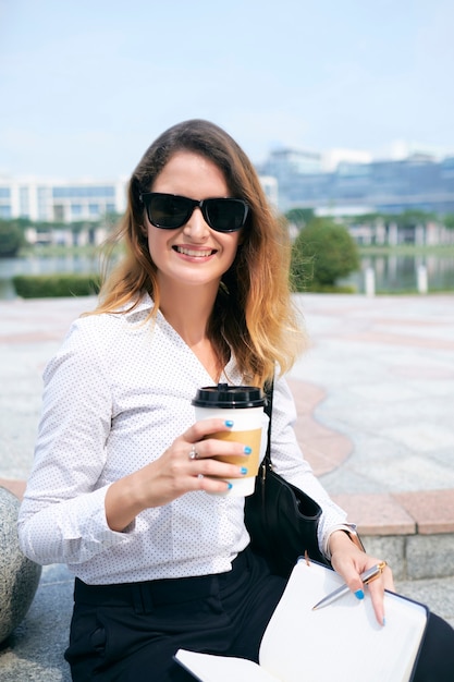 Mulher de negócios feliz com uma xícara de café