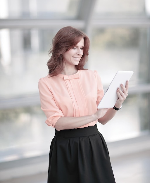 Mulher de negócios jovem com tablet digital no lobby do escritório