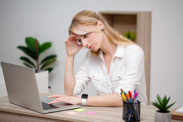 Mulher de negócios trabalhando em seu laptop no escritório.