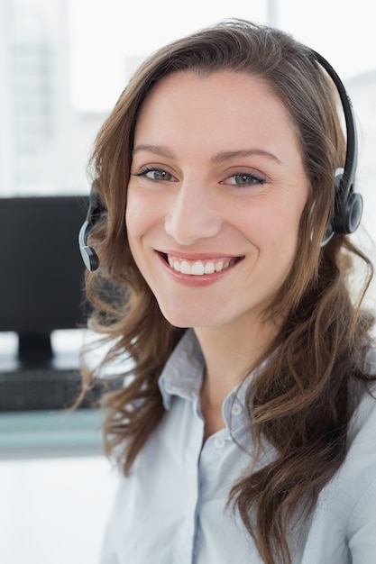 Mulher de negócios usando fone de ouvido na frente do computador