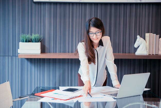 Mulher de negócios usando laptop no escritório
