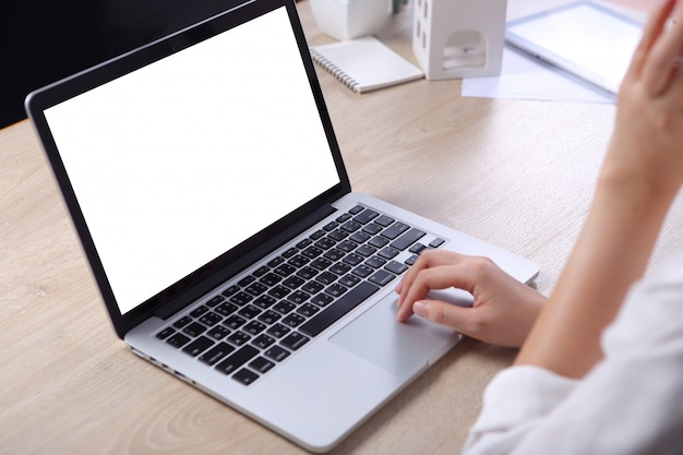 Mulher de negócios usando mock up laptop na mesa de madeira