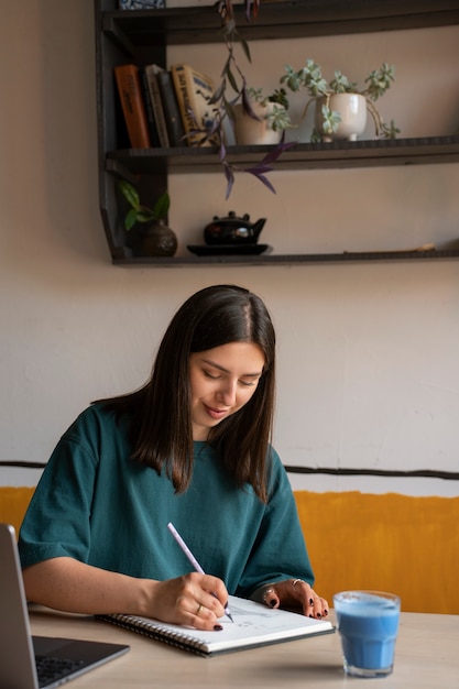 Mulher de tamanho médio a desfrutar de um matcha azul.