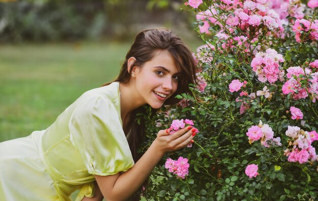 Mulher de verão no jardim de rosas ao ar livre garota de beleza natural aproveite a recreação da primavera