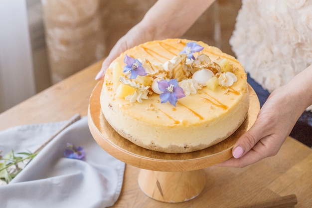 Mulher decorada cheesecake de maçã com caramelo.