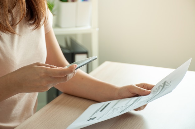 Mulher digitalizando um documento com um smartphone