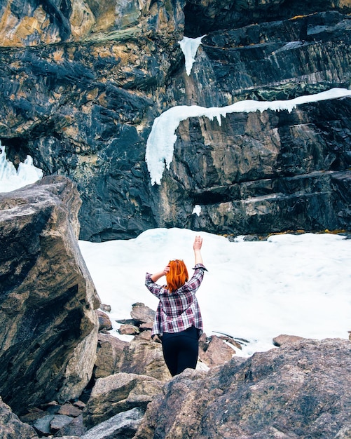 Foto mulher do viajante da liberdade que está nas montanhas congeladas