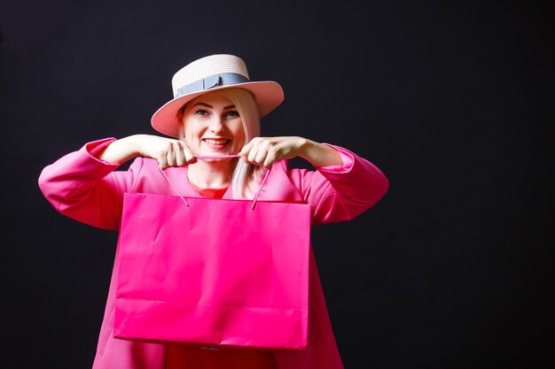 Mulher elegante segurando sacolas pretas, conceito de sexta-feira negra