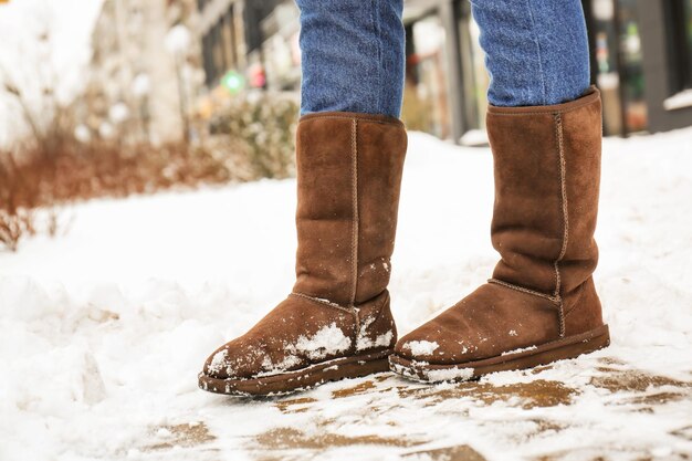 Mulher elegante usando sapatos quentes na rua da cidade no inverno