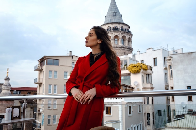 Mulher em pé no café do telhado com Istambul no fundo, vista da Torre Gálata em Beyoglu, Turquia. Viagem e férias no conceito de Turquia