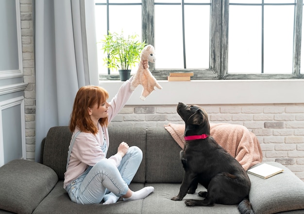 Foto mulher em plena cena e adorável cachorro no sofá