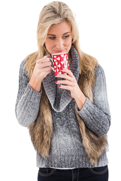 Mulher em roupas de inverno segurando uma caneca