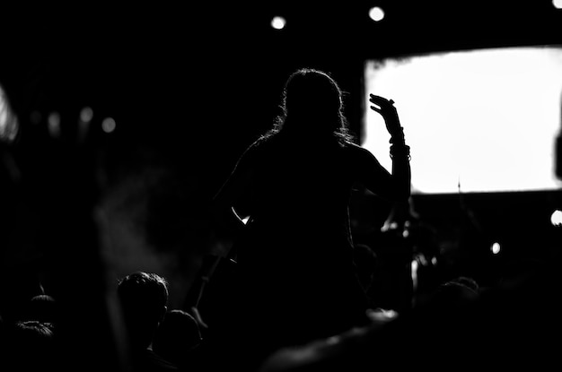 Mulher em silhueta num concerto de música