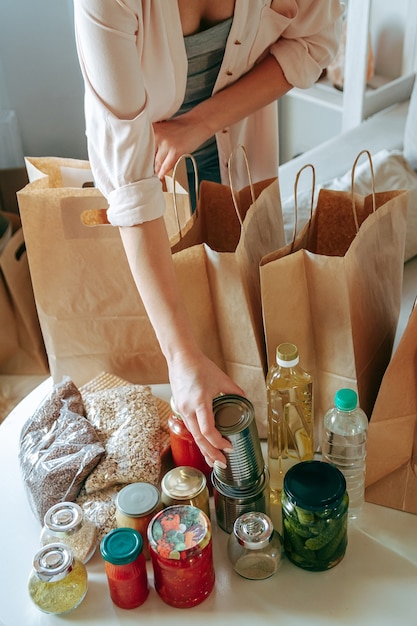 Mulher embalando comida para doação em saco de papel