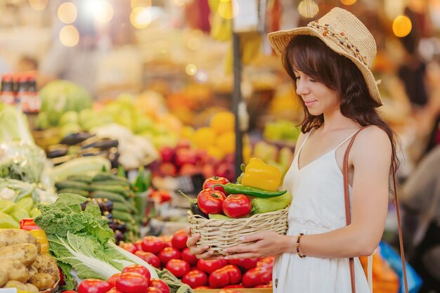 Mulher escolhe frutas e vegetais no mercado de alimentos.